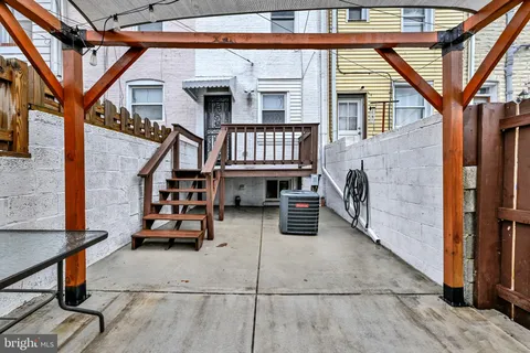 a brick building with a bench in front of it