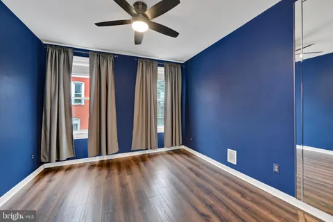 a view of a livingroom with wooden floor and a window