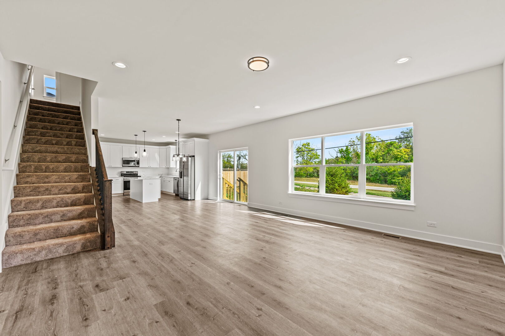 715 Fox Trail Terrace Cary, IL 60013 - Photo 3 of 22 an empty room with wooden floor and windows