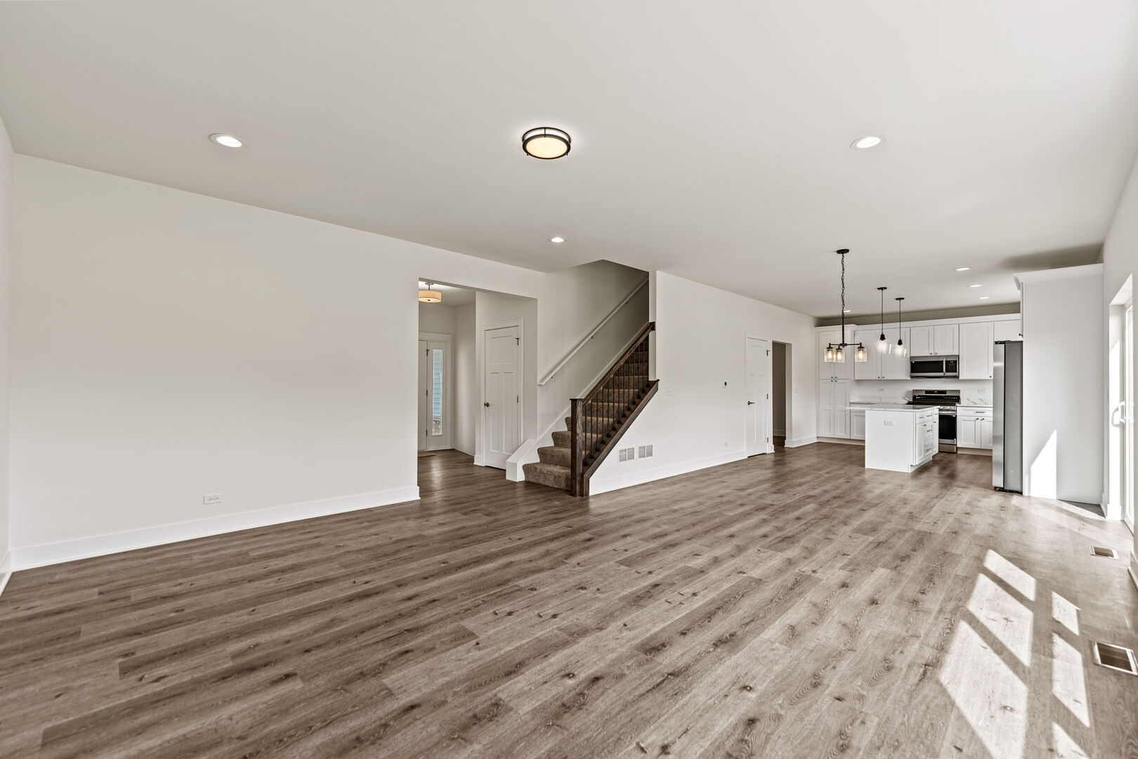 715 Fox Trail Terrace Cary, IL 60013 - Photo 4 of 22 a view of a livingroom with a kitchen and a wooden floor