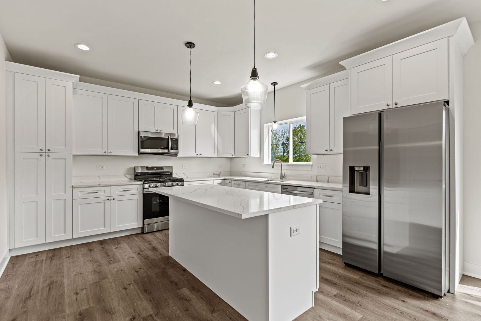 715 Fox Trail Terrace Cary, IL 60013 - Photo 5 of 22 a kitchen with kitchen island white cabinets and refrigerator