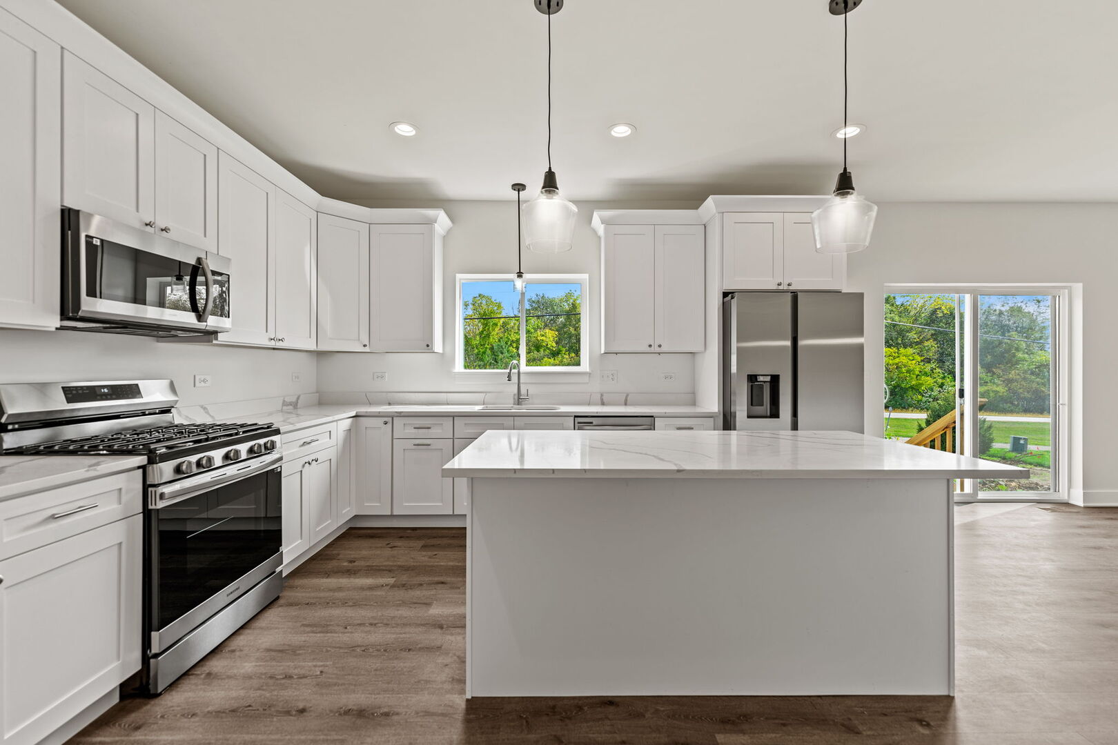 715 Fox Trail Terrace Cary, IL 60013 - Photo 6 of 22 a kitchen with stainless steel appliances granite countertop a stove a sink and a refrigerator