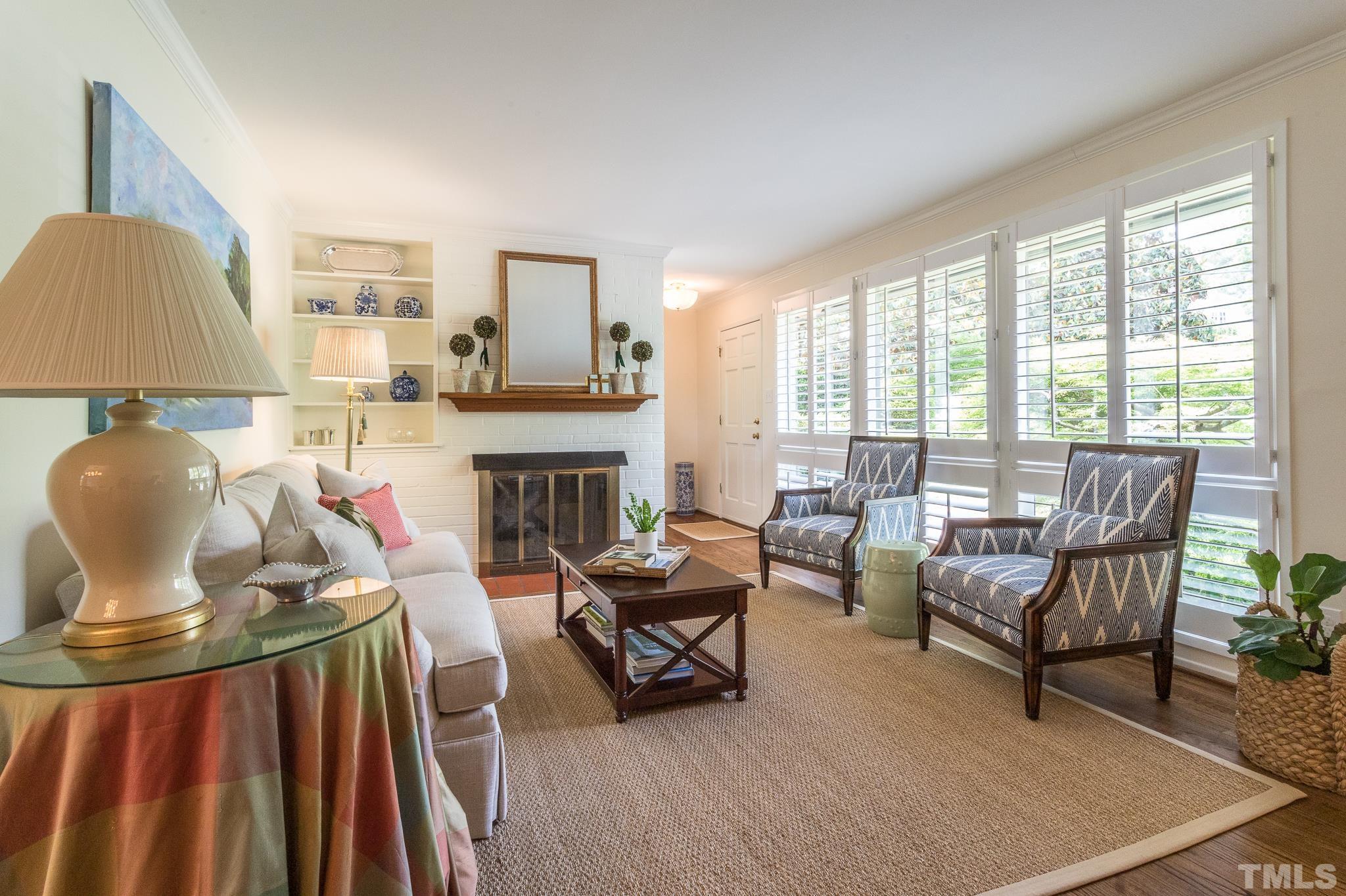 3431 Churchill Road Raleigh, NC 27607 - Photo 18 of 47 a living room with furniture and a fireplace