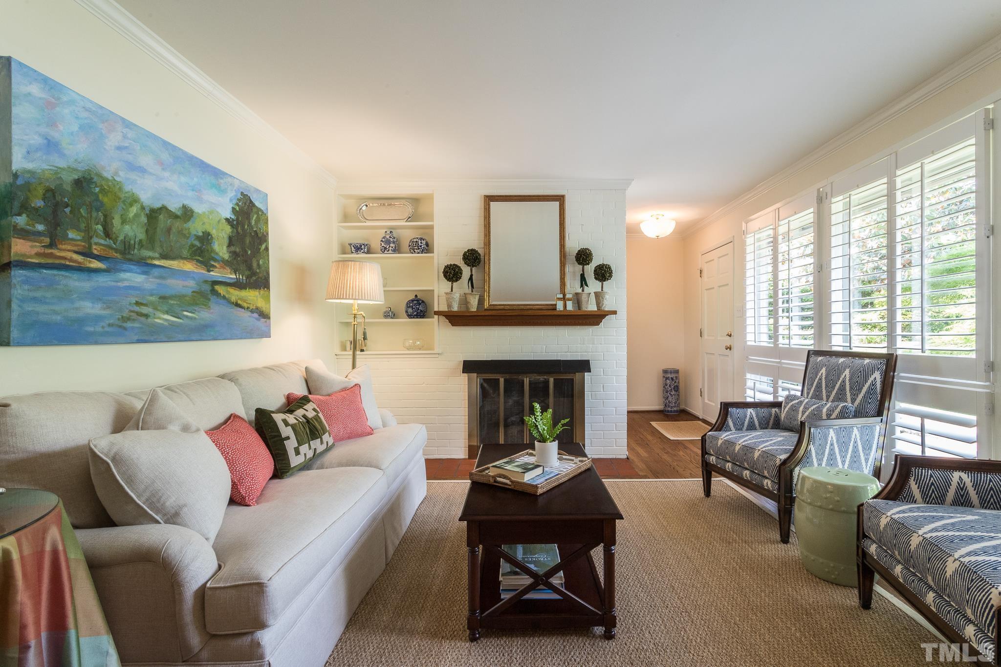 3431 Churchill Road Raleigh, NC 27607 - Photo 19 of 47 a living room with furniture and a fireplace