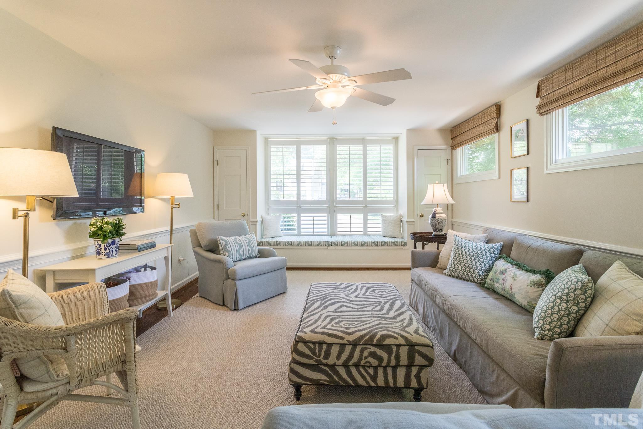 3431 Churchill Road Raleigh, NC 27607 - Photo 25 of 47 a living room with furniture a large window and a chandelier