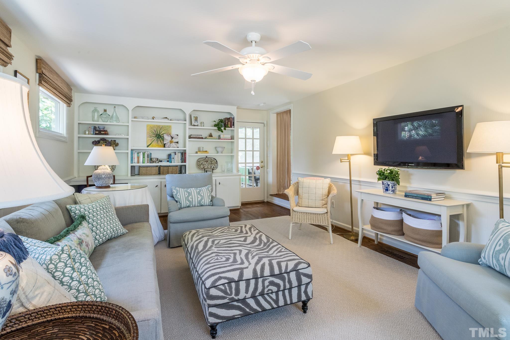 3431 Churchill Road Raleigh, NC 27607 - Photo 28 of 47 a living room with furniture or couch and a flat screen tv