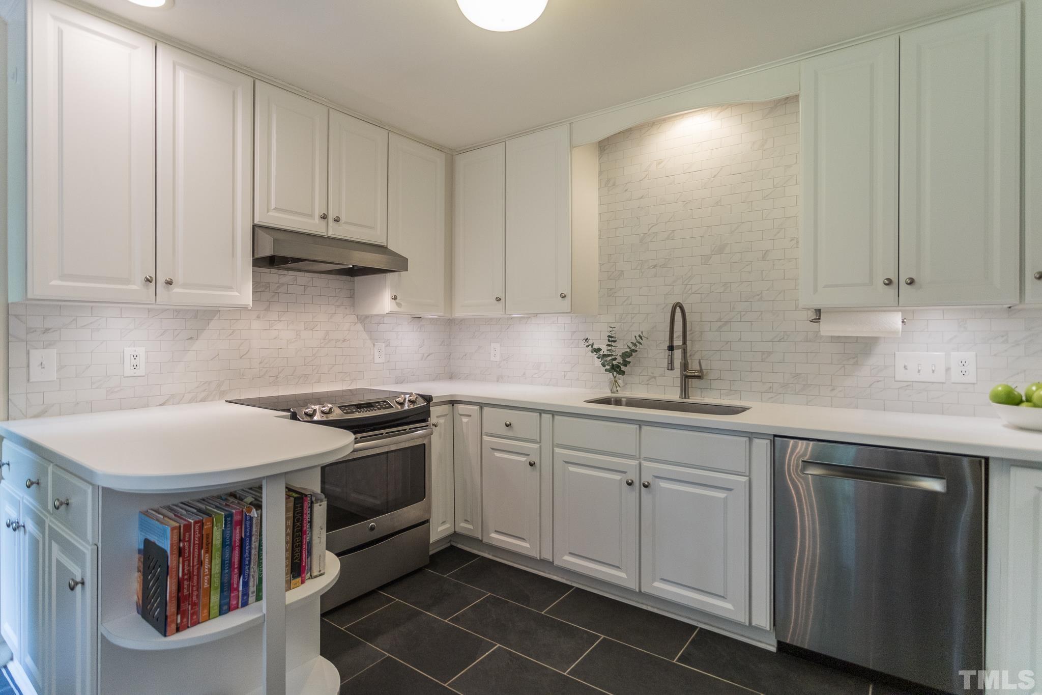 3431 Churchill Road Raleigh, NC 27607 - Photo 32 of 47 a kitchen with stainless steel appliances granite countertop a sink and cabinets