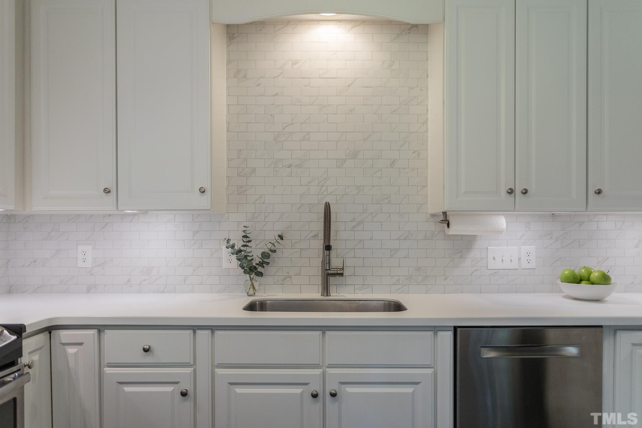 3431 Churchill Road Raleigh, NC 27607 - Photo 34 of 47 a kitchen with white cabinets and sink