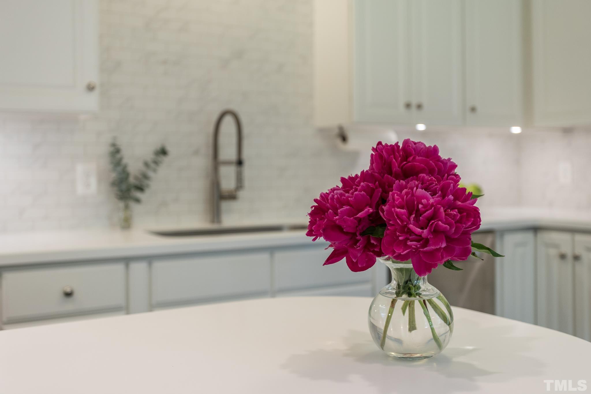 3431 Churchill Road Raleigh, NC 27607 - Photo 35 of 47 a close view of a sink a faucet a potted plant and a table