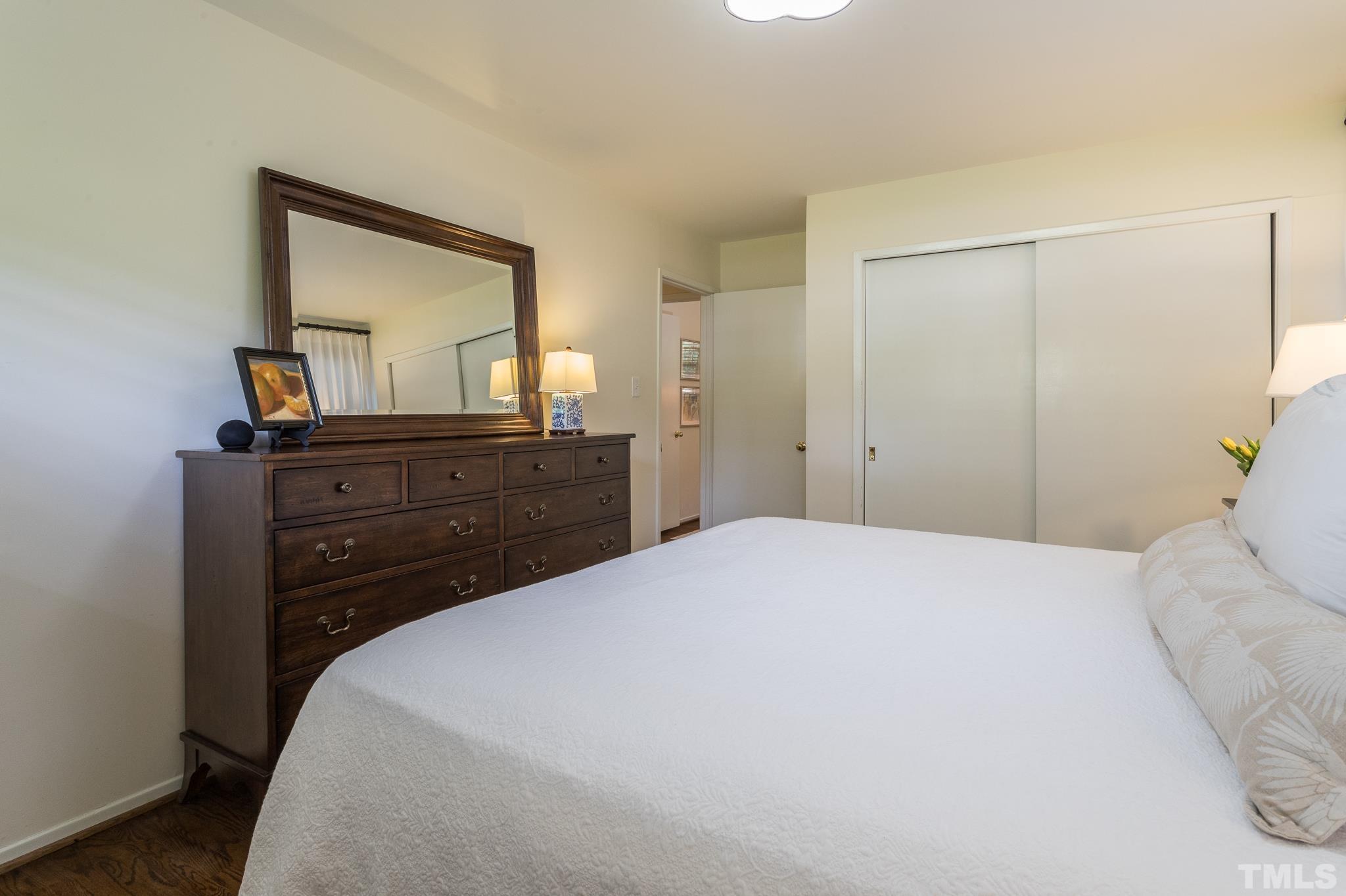 3431 Churchill Road Raleigh, NC 27607 - Photo 39 of 47 a bedroom with a bed and a dresser