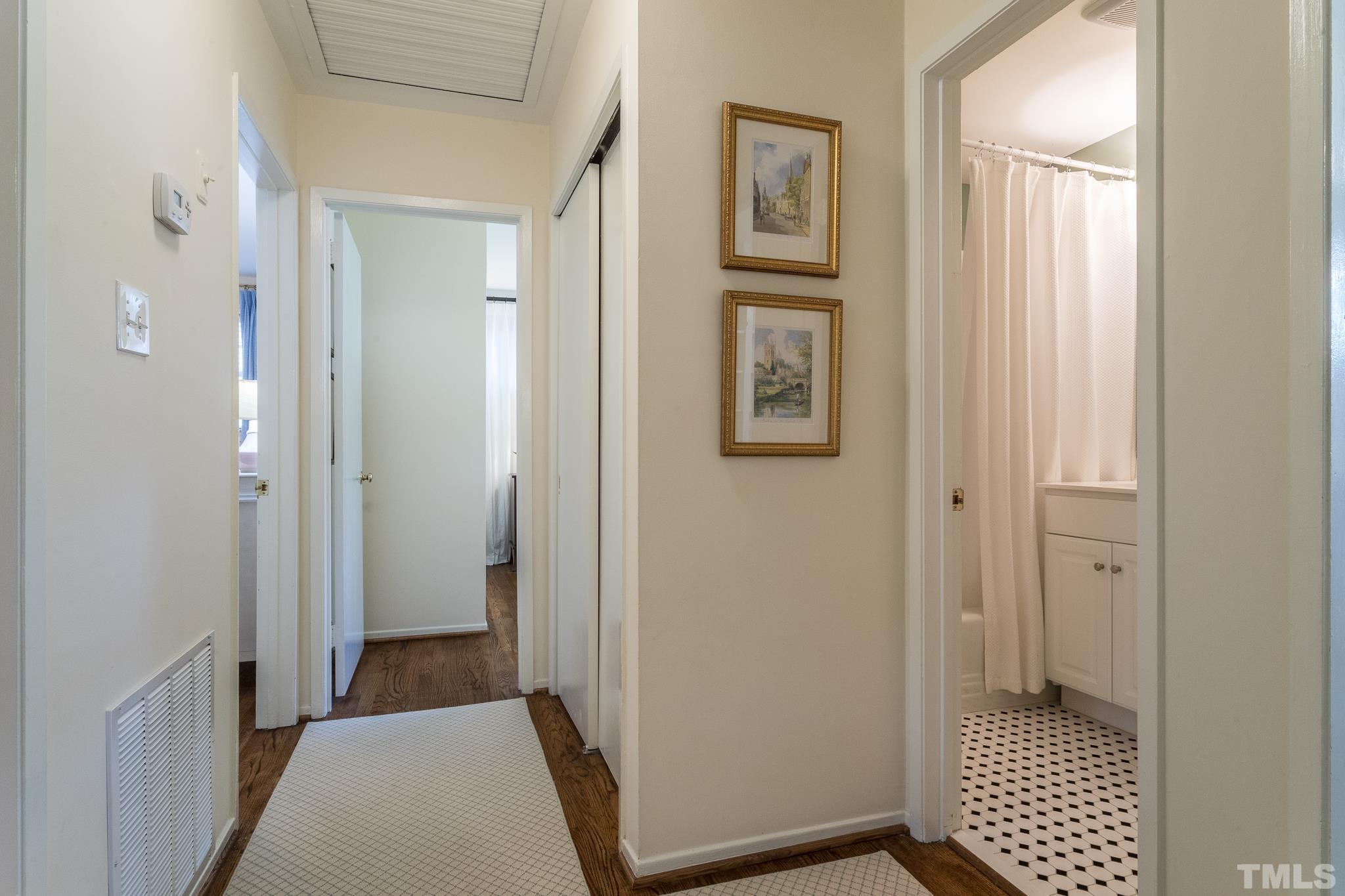 3431 Churchill Road Raleigh, NC 27607 - Photo 43 of 47 a view of a hallway with wooden floor and a bathroom