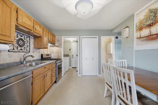 a kitchen with stainless steel appliances granite countertop a sink and cabinets