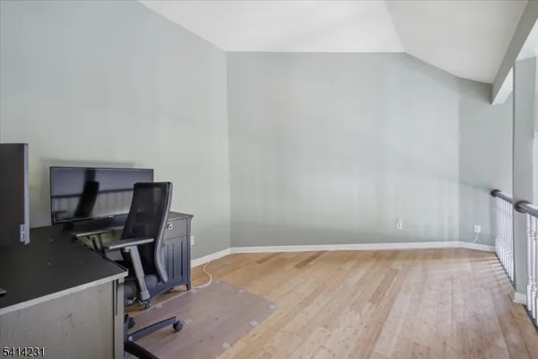 a view of workspace with wooden floor windows
