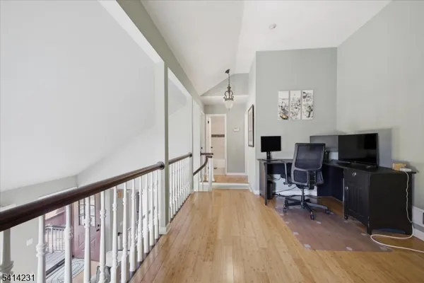 a view of a livingroom with workspace and a window