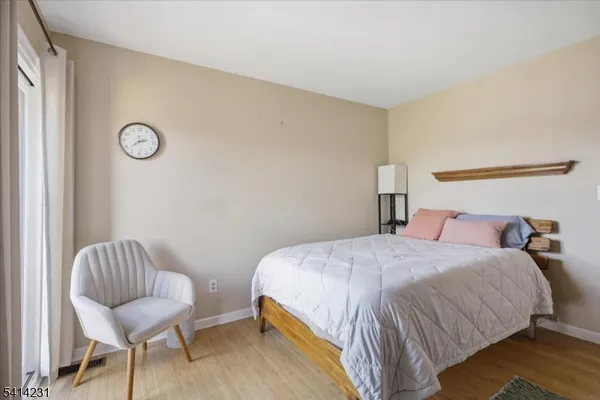 a bedroom with a bed and chair