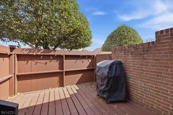 a view of balcony with wooden floor and outdoor seating