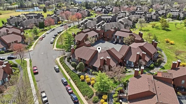 an aerial view of residential houses with outdoor space and swimming pool