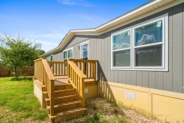 a view of a house with a yard and sitting area