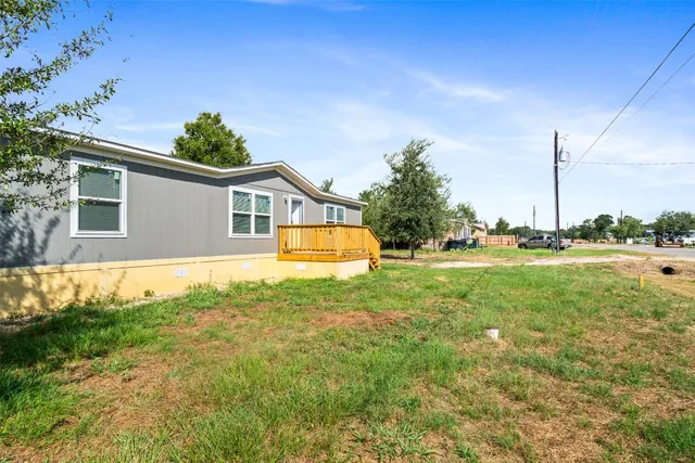 a view of a house with a yard and sitting area