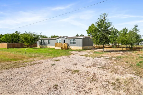 a view of a house with a yard and sitting area