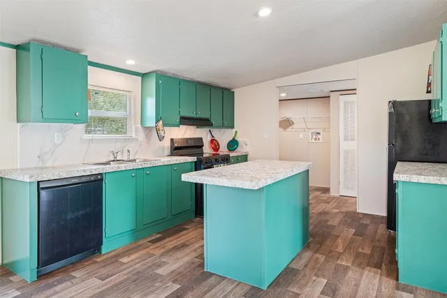 a stove top oven sitting inside of a kitchen