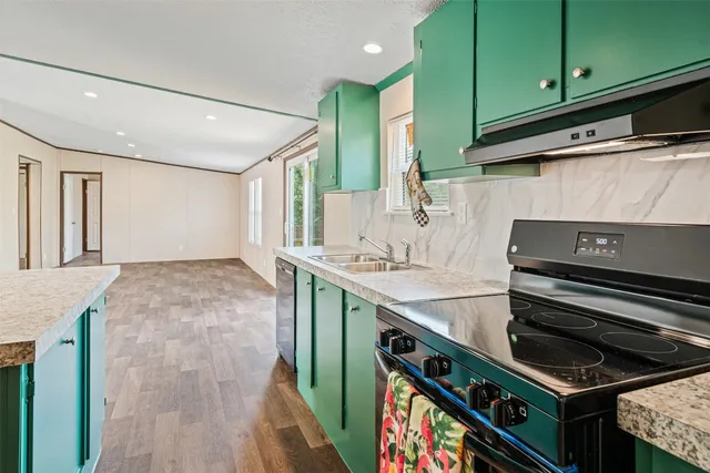 a bathroom with a granite countertop sink and washing machine