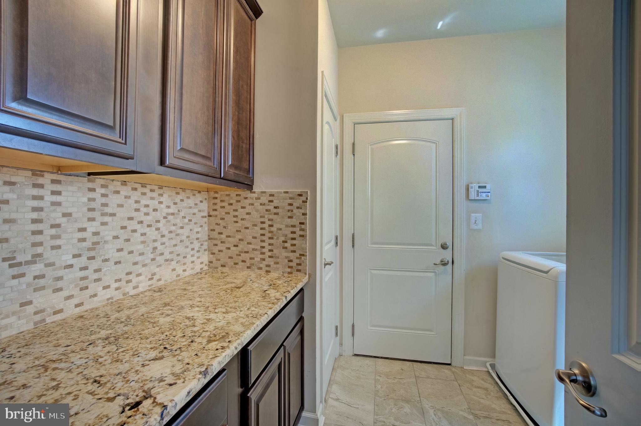 44369 Stone Roses Circle Ashburn, VA 20147 - Photo 31 of 45 Landry Room with Granite Countertop and Cabinets
