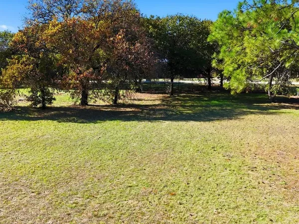 a view of swimming pool with yard and green space