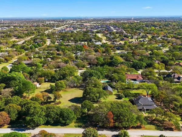 an aerial view of residential houses with city view
