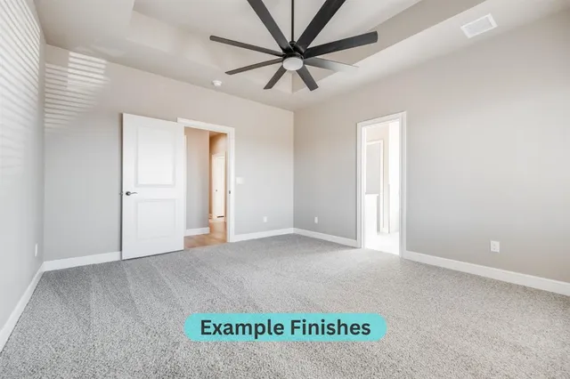 an empty room with a ceiling fan and a window