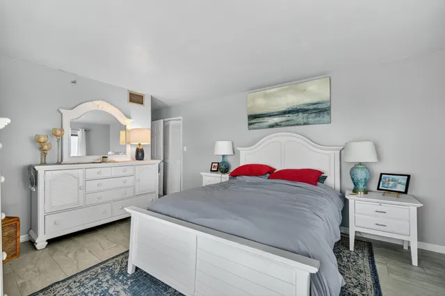 a view of a bedroom with a bed and a dresser