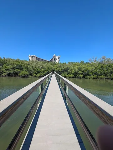 a view of balcony with lake and trees in the background