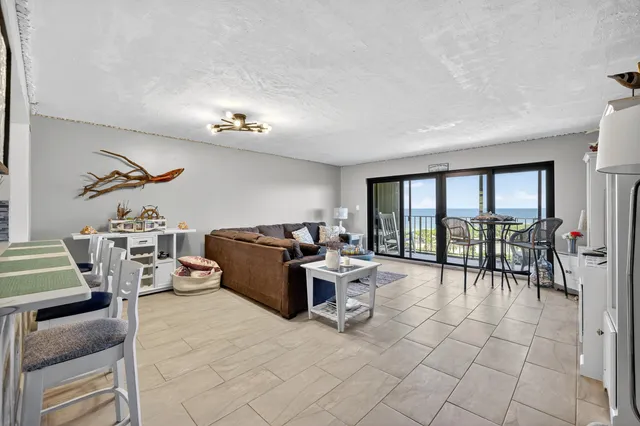 a living room with furniture large window and flat screen tv