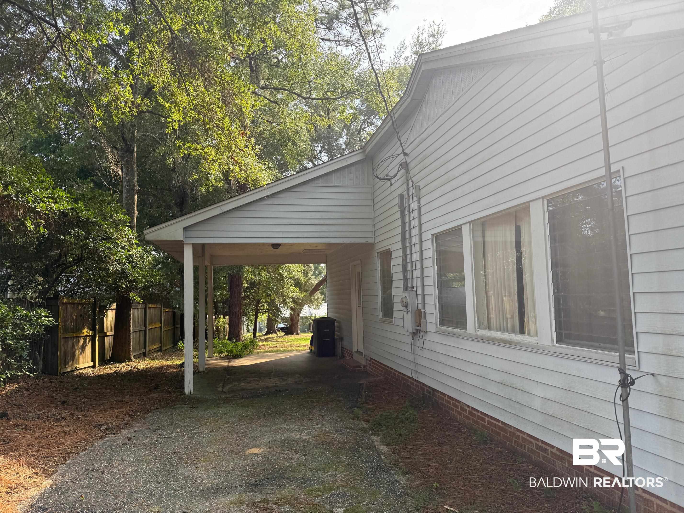 156 Pier Avenue Fairhope, AL 36532 - Photo 31 of 41 View of property exterior with a patio and a carport