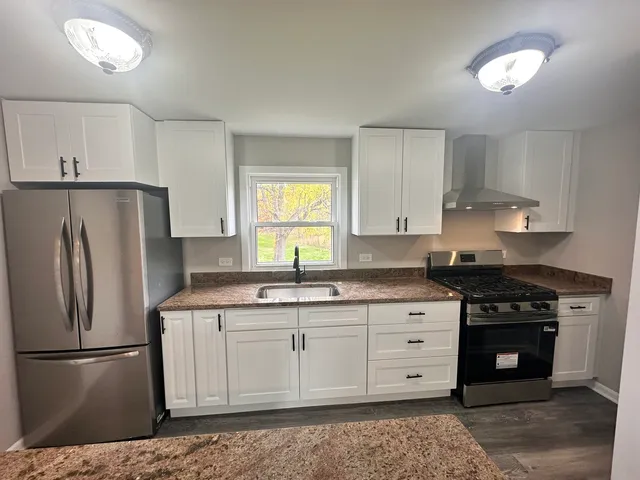 a kitchen with appliances cabinets and a sink