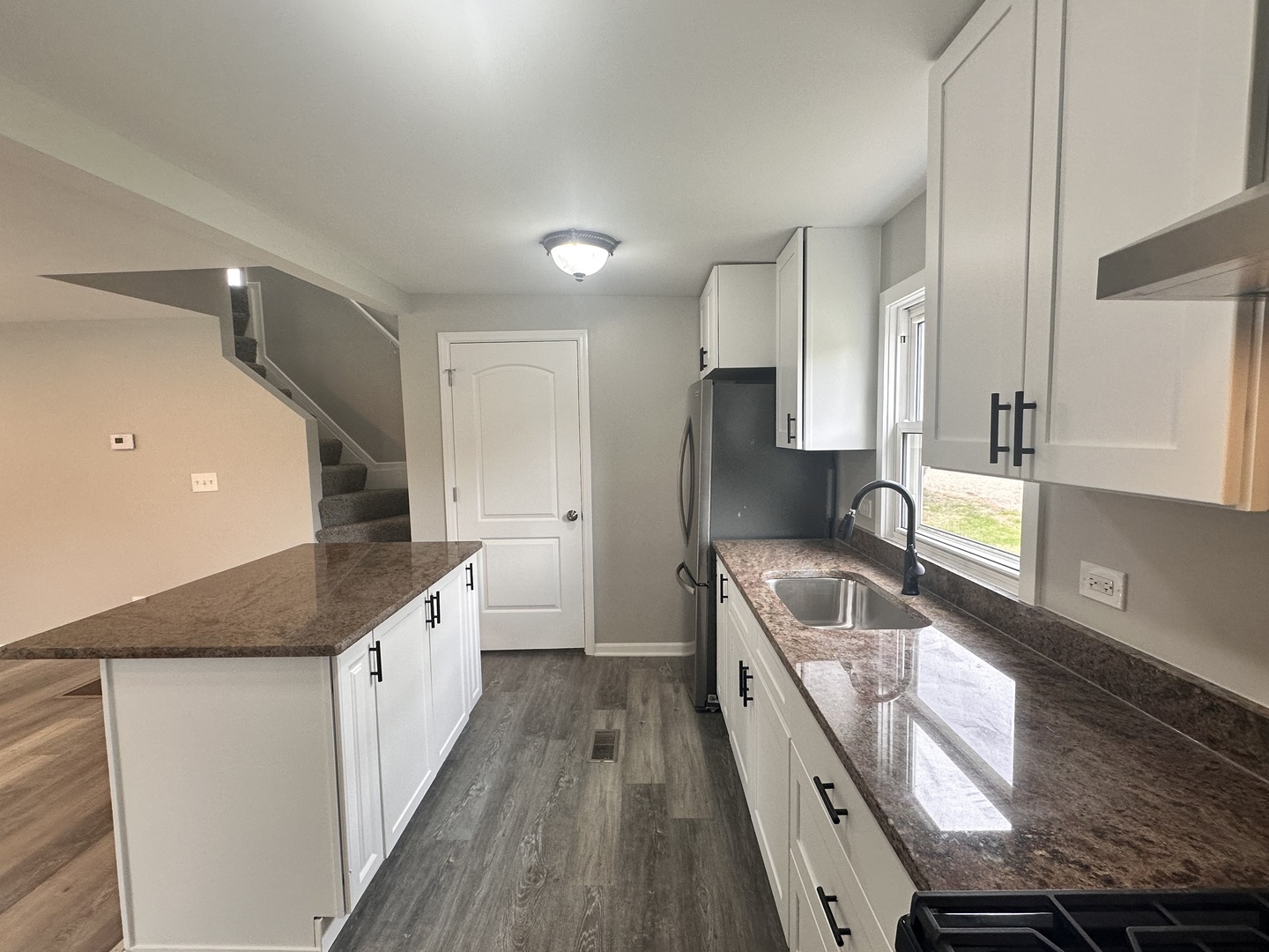 248 North State Street Franklin Grove, IL 61031 - Photo 13 of 26 a kitchen with granite countertop a sink and wooden cabinets