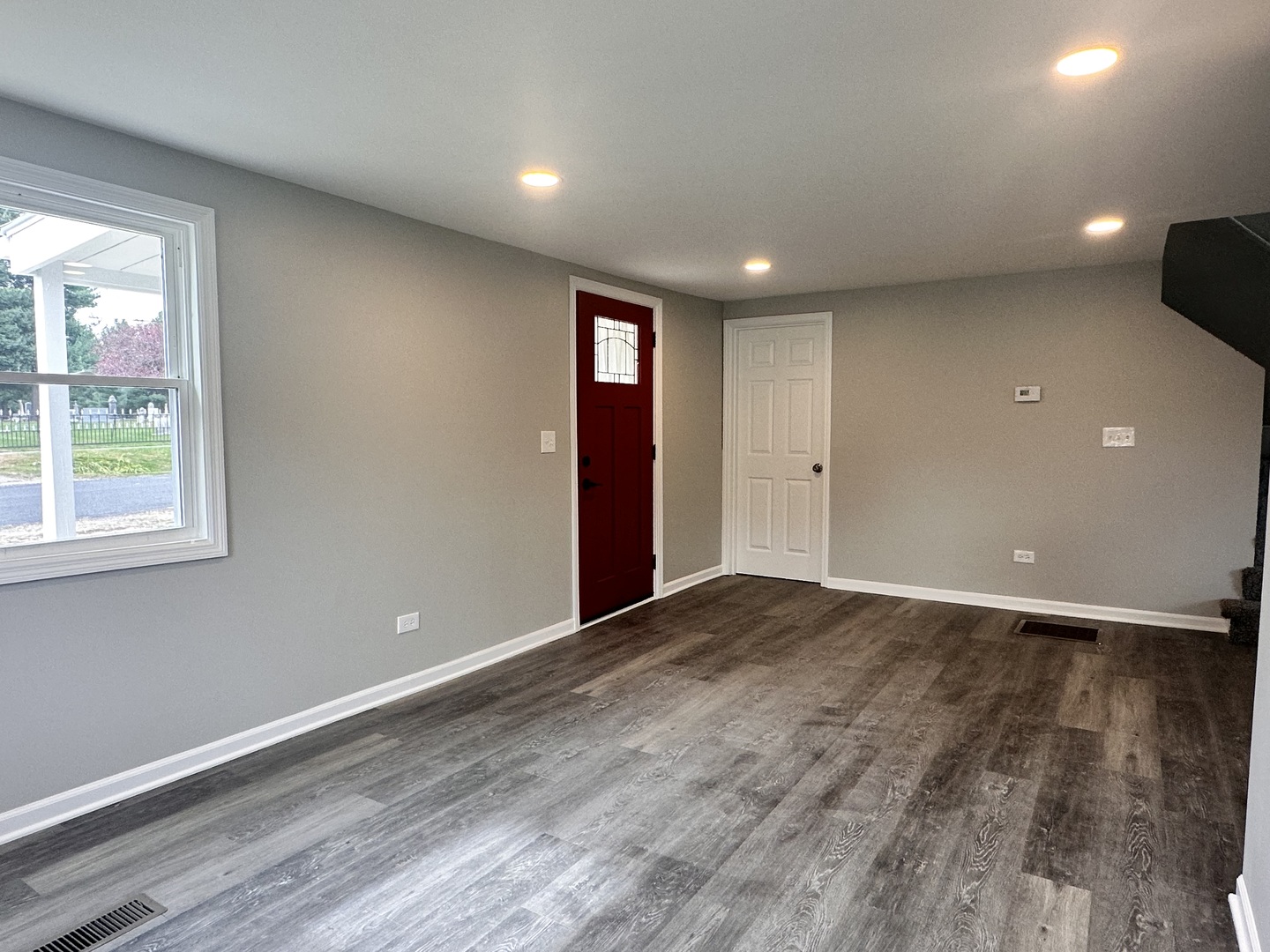 248 North State Street Franklin Grove, IL 61031 - Photo 8 of 26 an empty room with wooden floor and windows