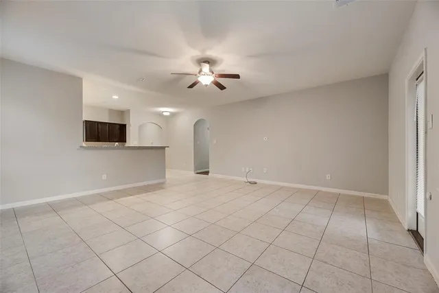 an empty room with a empty space and a ceiling fan window