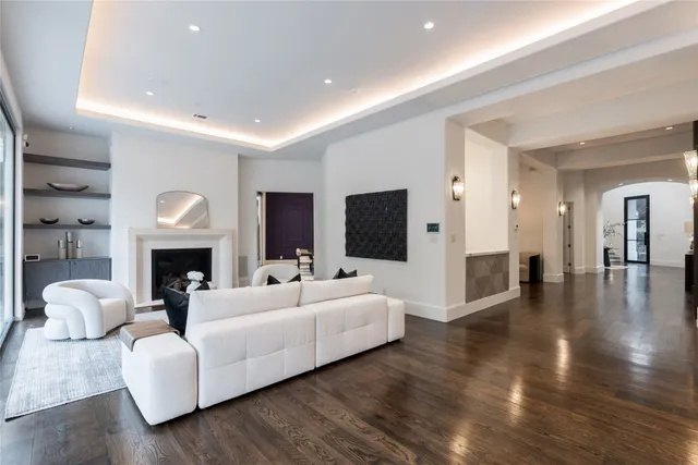a dining room with furniture a chandelier and wooden floor