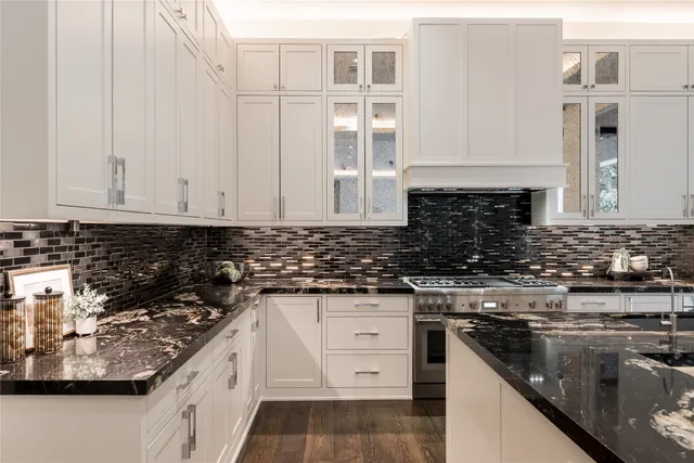 a kitchen with stainless steel appliances a stove top oven a sink and a refrigerator