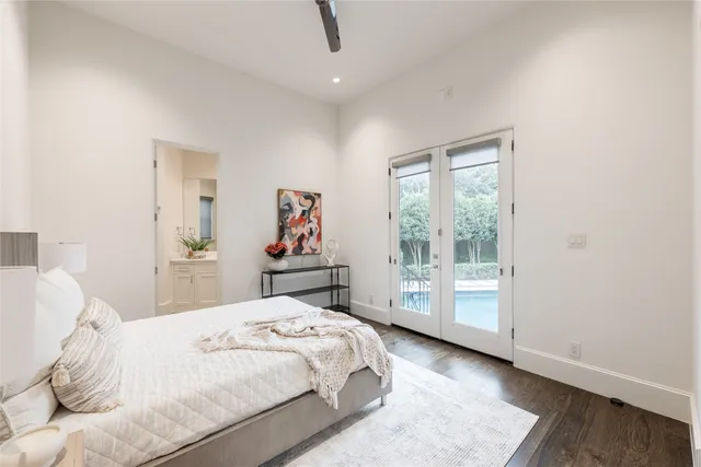 a spacious bathroom with a double vanity sink a mirror and a bathtub