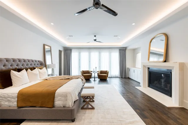 a bathroom with a granite countertop sink a toilet a mirror and shower