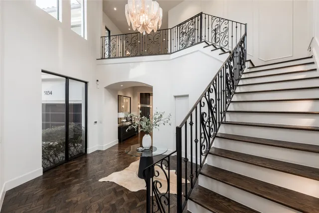 a dining room with furniture and a chandelier