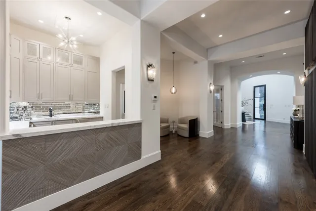 a kitchen with granite countertop a sink a stove and cabinets