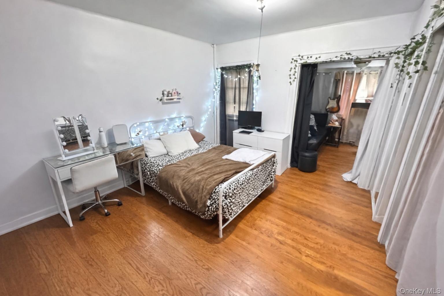 86-75 80th Street Queens, NY 11421 - Photo 14 of 29 a bedroom with a bed window and a table
