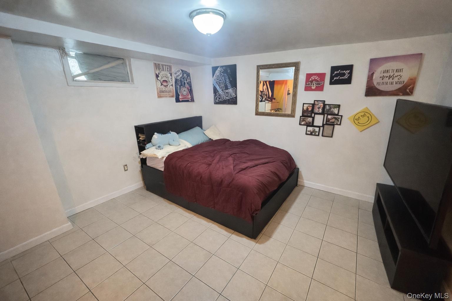 86-75 80th Street Queens, NY 11421 - Photo 15 of 29 a bedroom with a bed and a desk