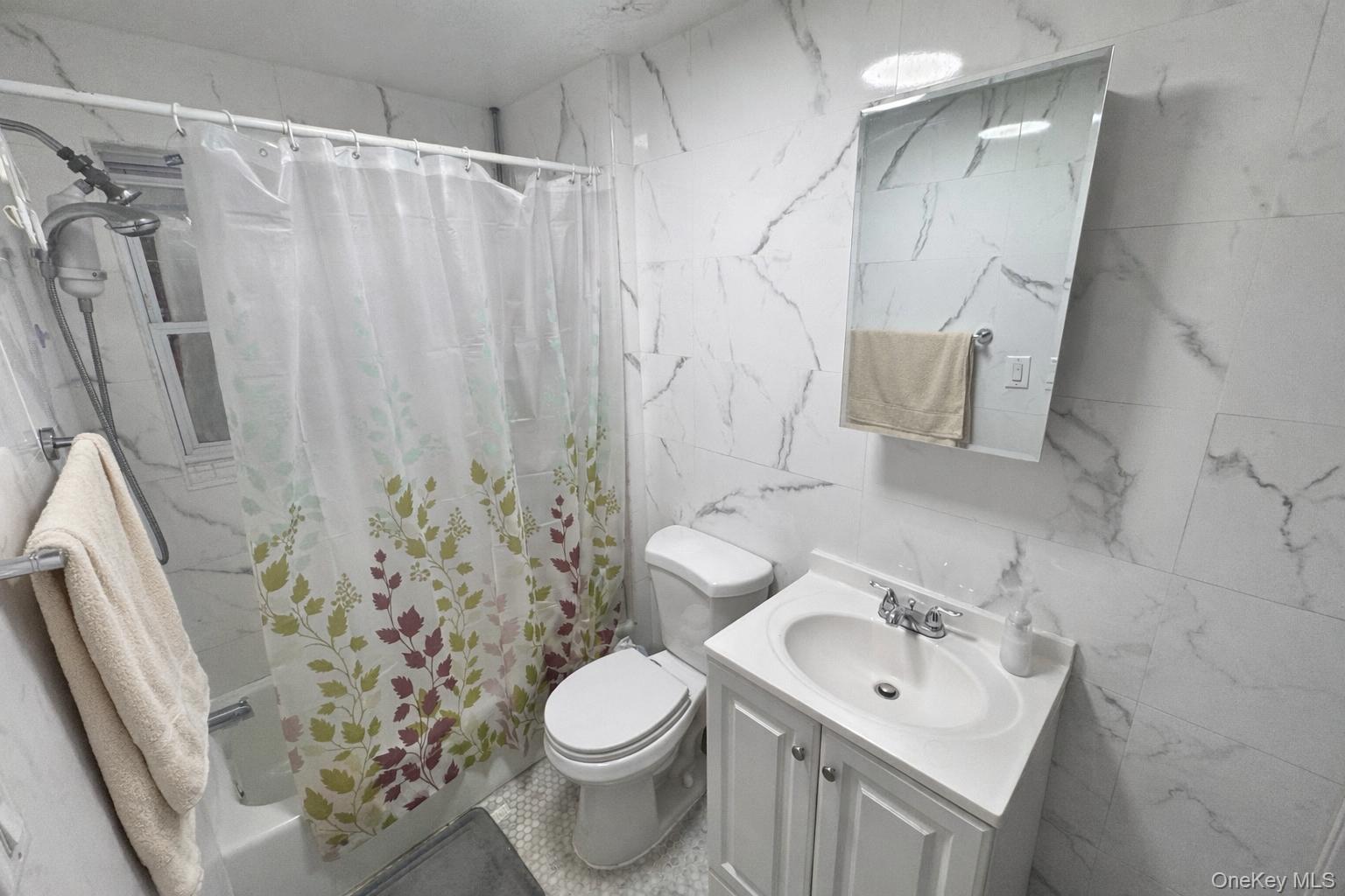 86-75 80th Street Queens, NY 11421 - Photo 19 of 29 a bathroom with a sink toilet and shower