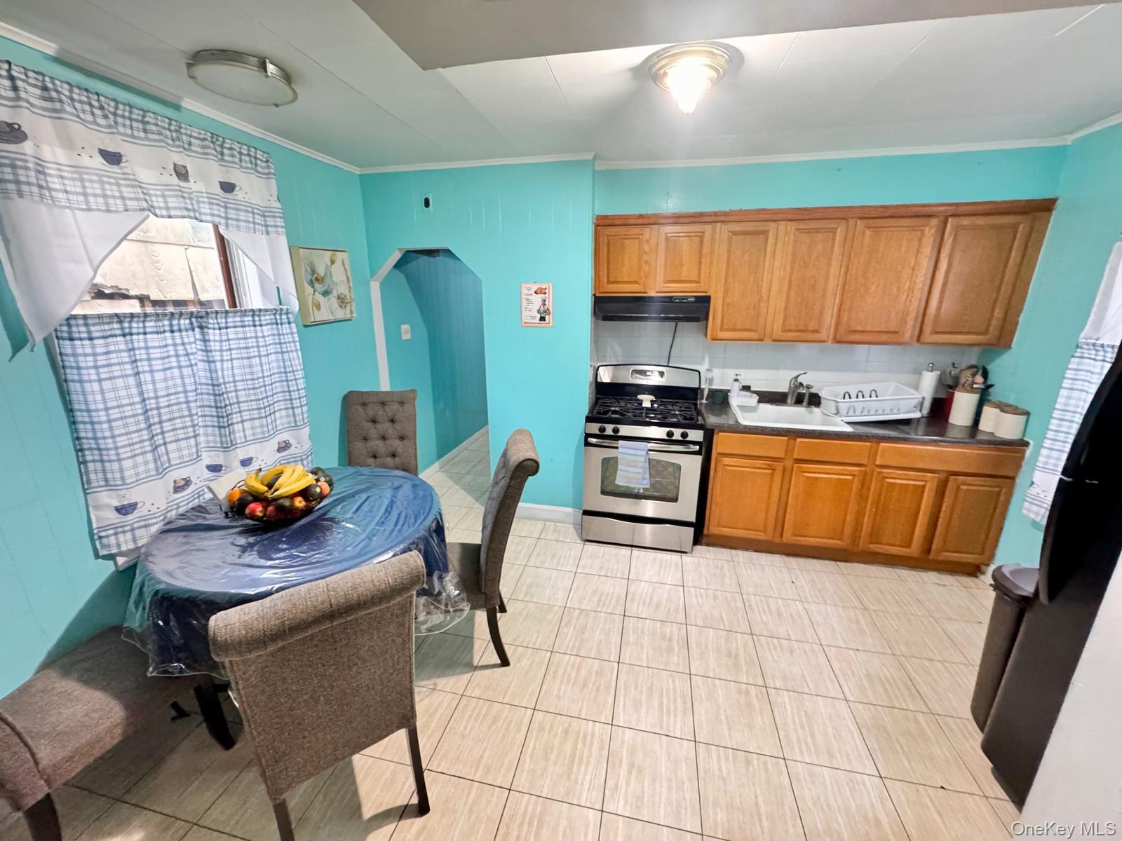 86-75 80th Street Queens, NY 11421 - Photo 4 of 29 a kitchen with stainless steel appliances a stove a sink a counter top space and cabinets