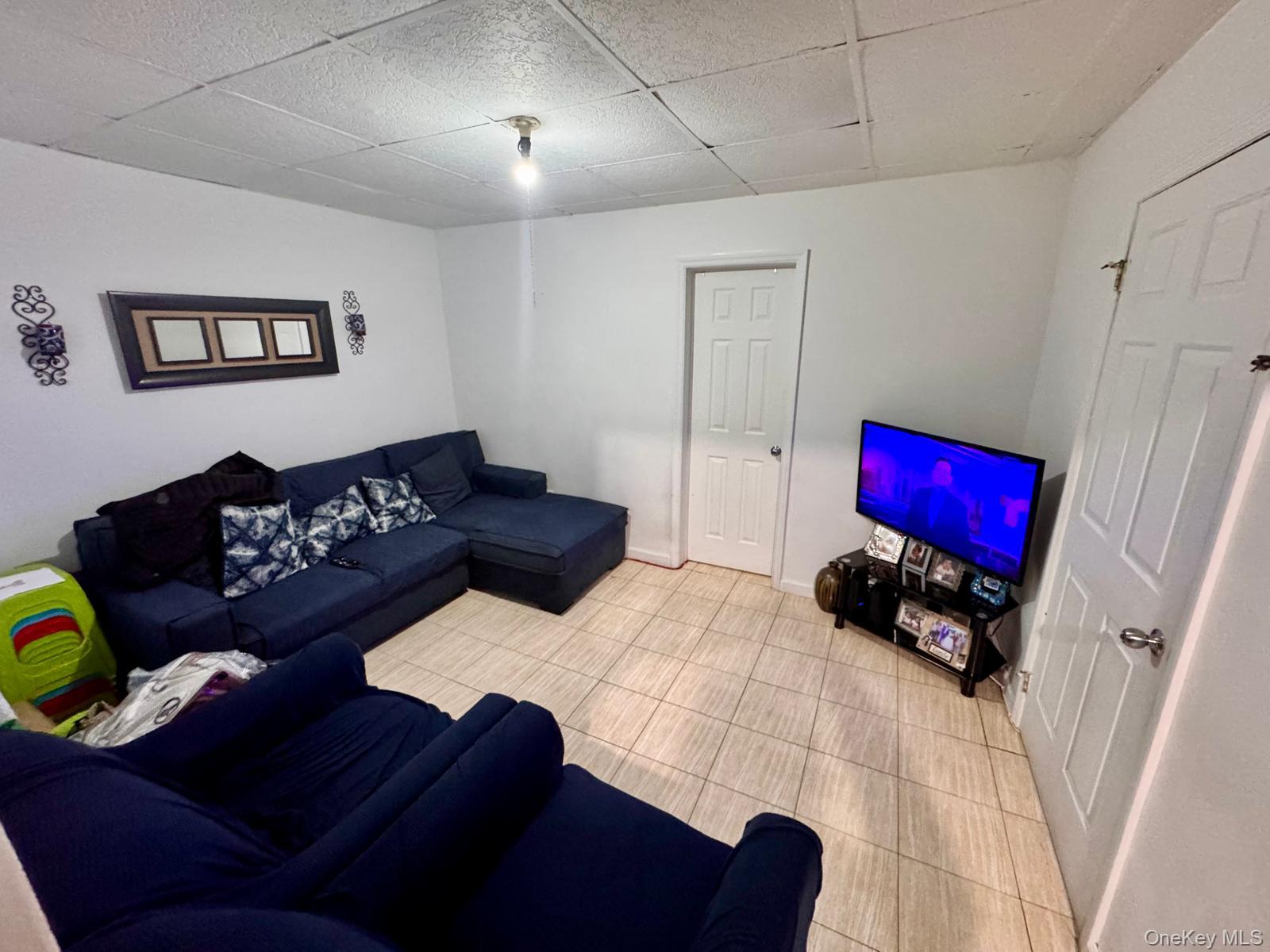 86-75 80th Street Queens, NY 11421 - Photo 7 of 29 a living room with furniture and a couch