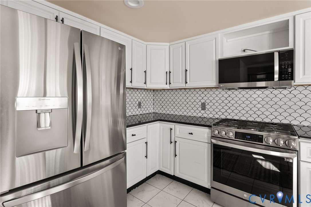 467 Blundon Road Reedville, VA 22539 - Photo 13 of 35 a kitchen with stainless steel appliances a stove microwave and refrigerator